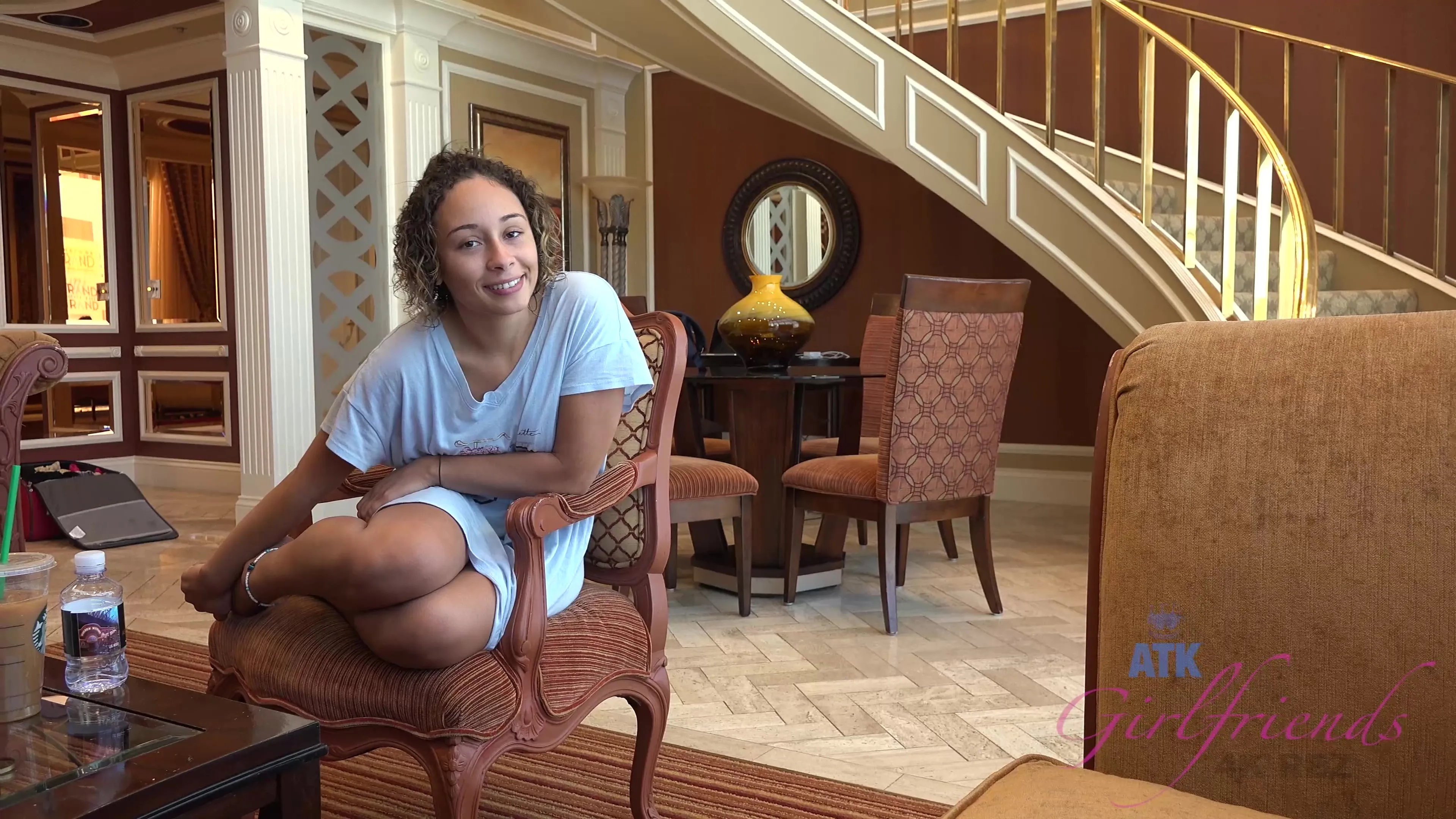 Curly amateur gives a footjob